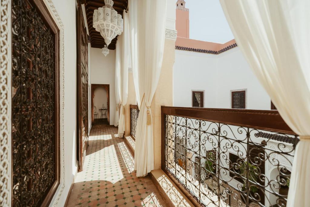 a hallway of a house with a chandelier at Riad Dar Dialkoum in Marrakesh