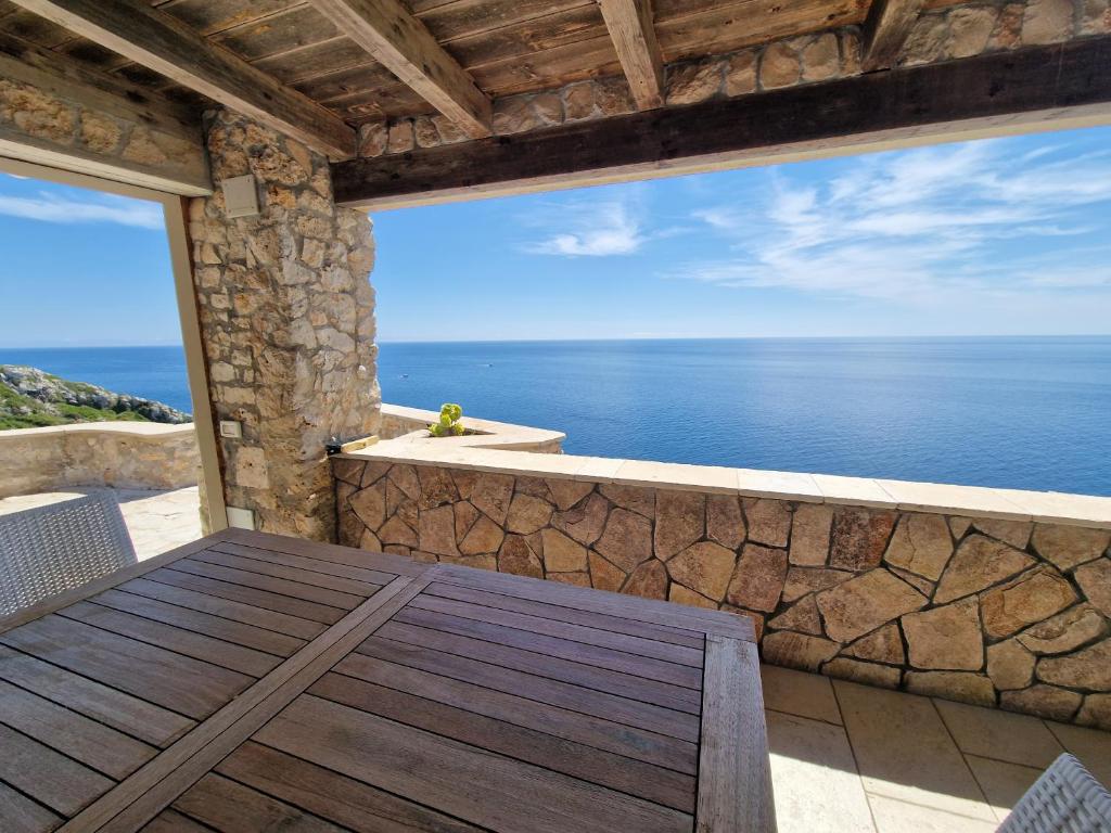 a balcony with a view of the ocean at Oliventu - Tra gli ulivi sul mare in Leuca