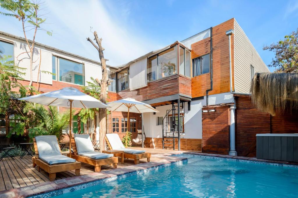 an exterior view of a house with a swimming pool at Verde Madera Hostel B&B in Santiago