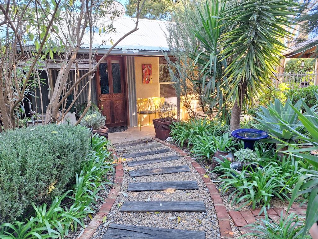 a garden with a walkway in front of a house at Little Para Cottage Tanunda in Tanunda