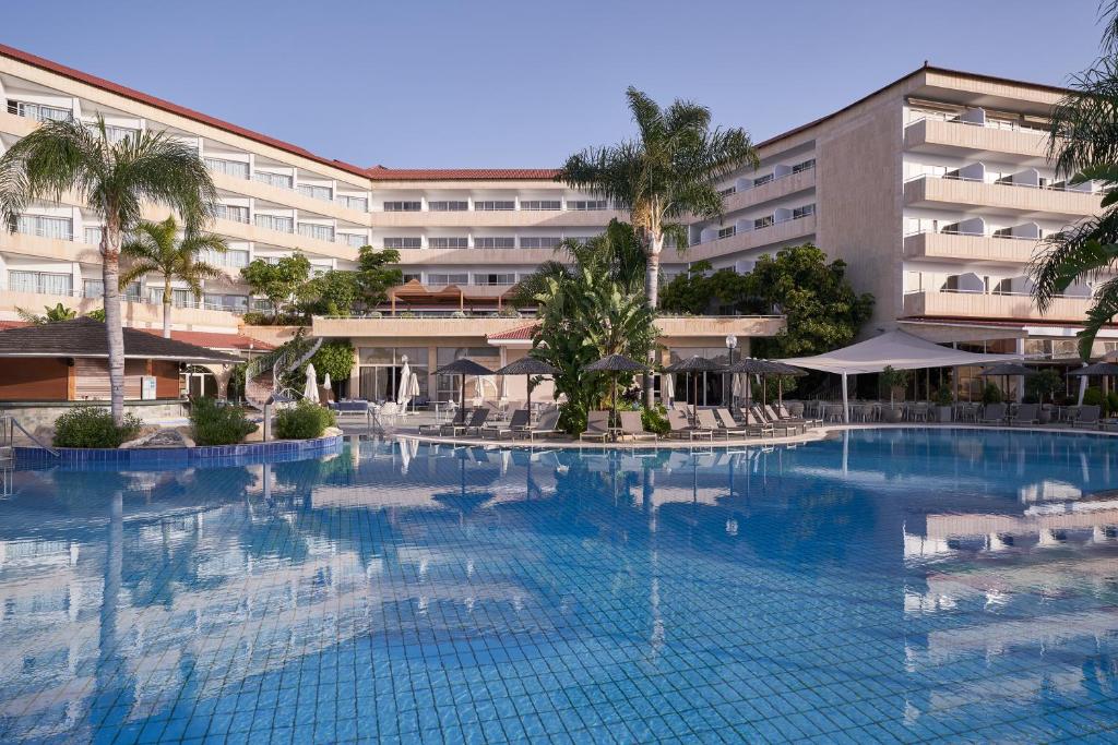 a large swimming pool in front of a hotel at Atlantica Bay - Adults Only in Limassol