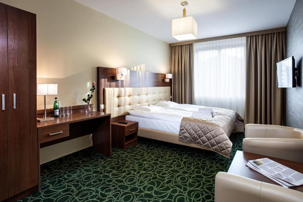 Łóżko lub łóżka w pokoju w obiekcie Hotel Royal Botanic
