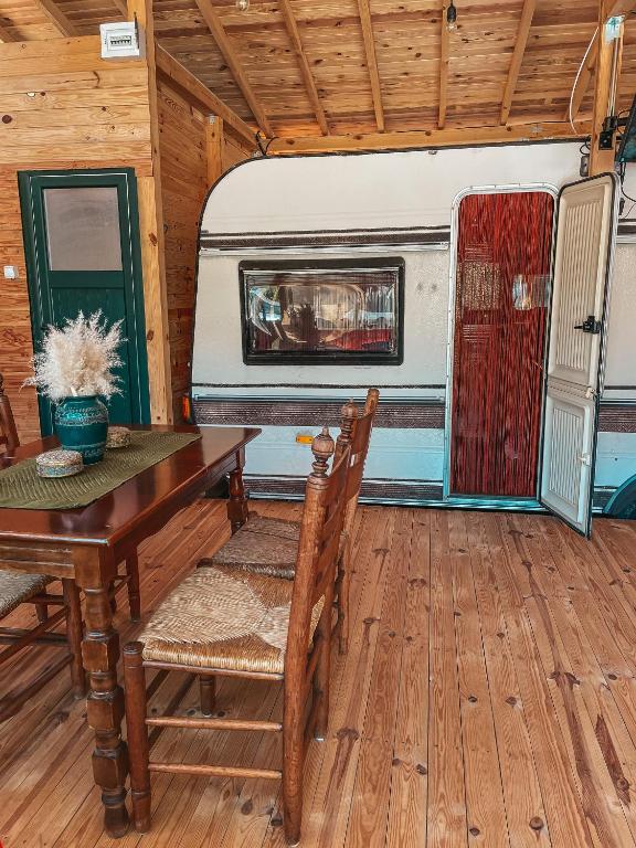a dining room with a table and a trailer at Каравана GYPSY in Chernomorets