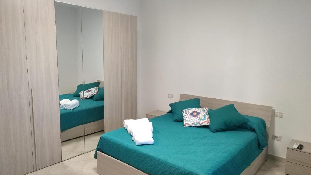 a bedroom with two beds and a mirror at Lovin Puglia Vacation in Bari