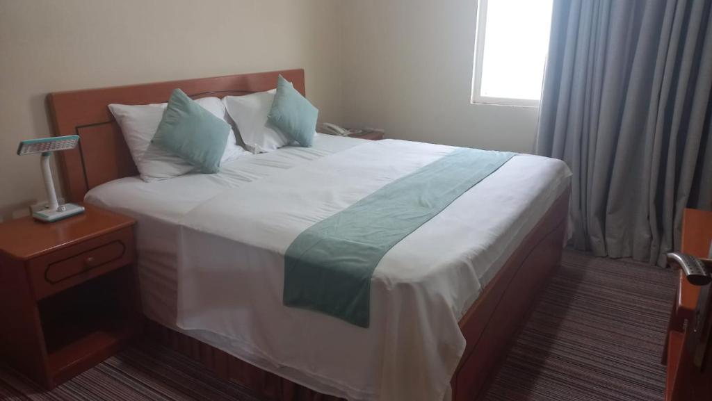 Postel nebo postele na pokoji v ubytování Al Jazeerah Hotel
