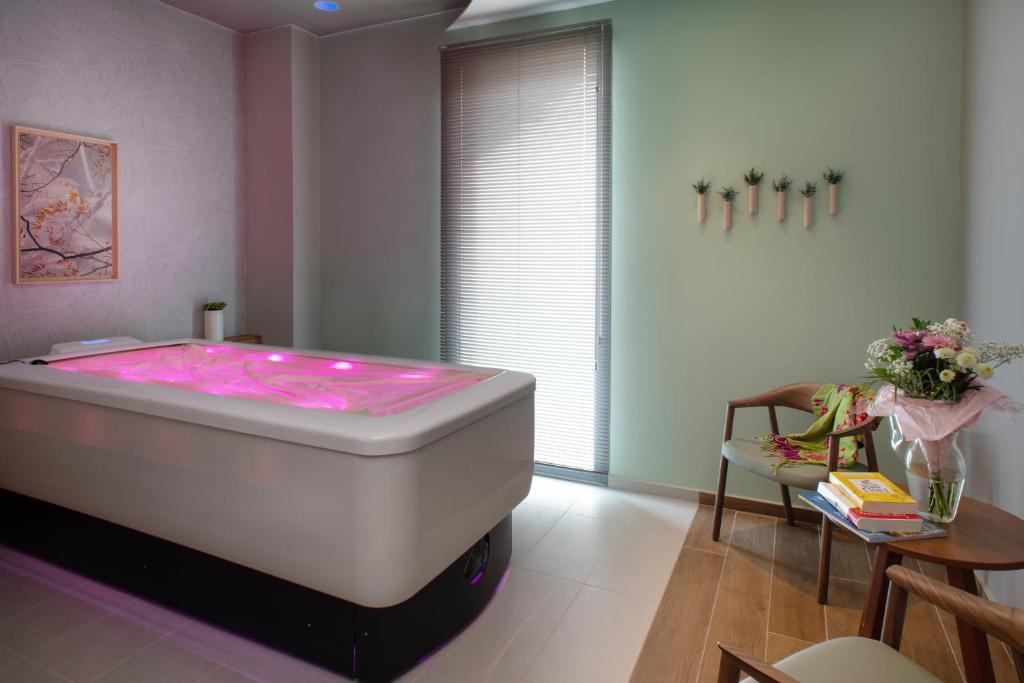 a room with a large white tub in a room at DOMITYS LES CERNEAUX in Hazebrouck