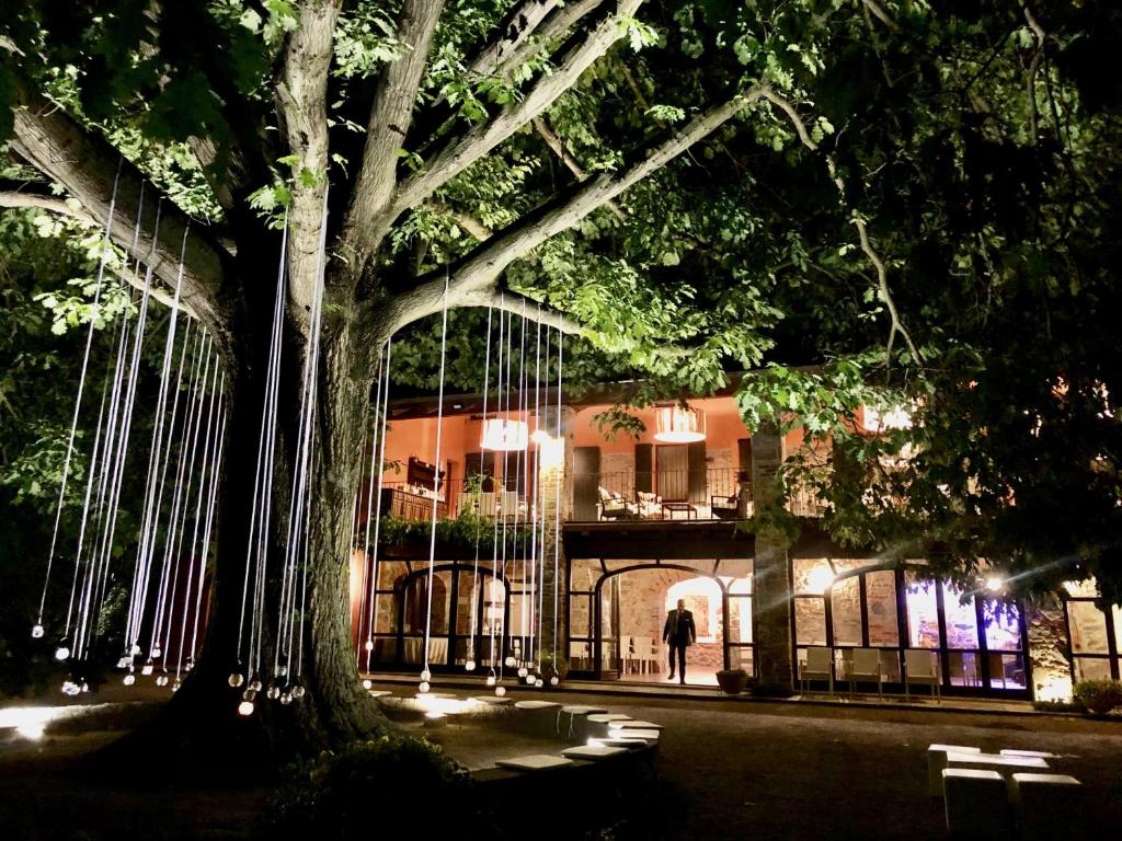 a person walking in front of a building at night at Tenuta La Quassa in Ispra