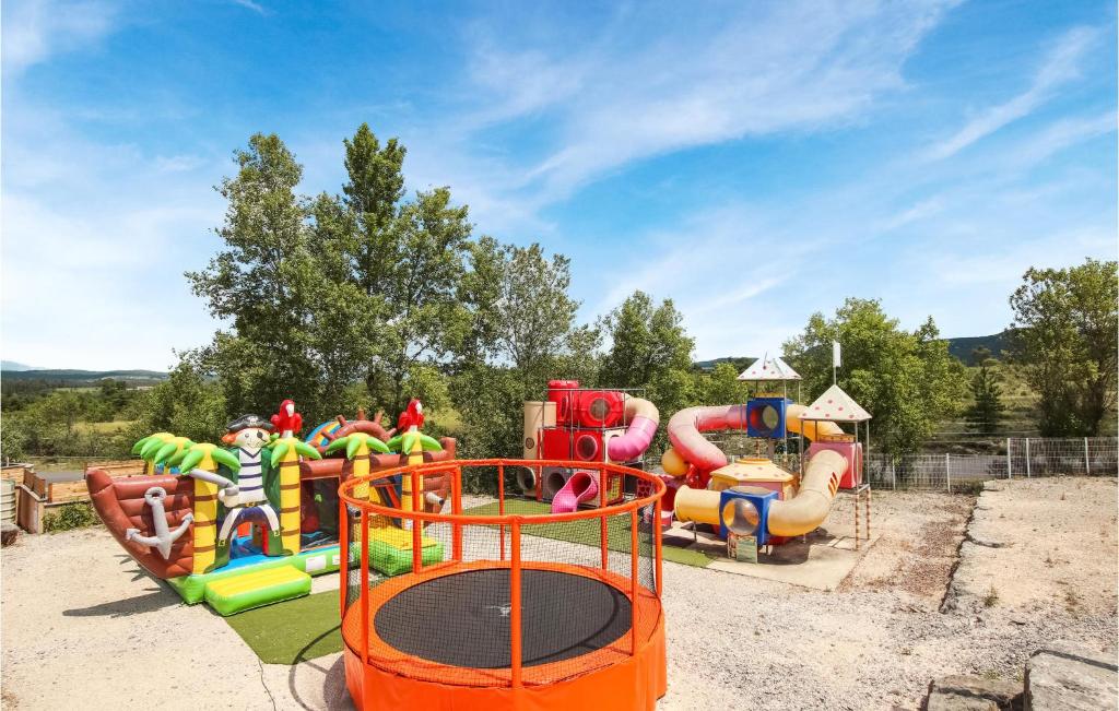 a childrens playground with an inflatable water park at Amazing Home In Grospierres With Outdoor Swimming Pool, Wifi And 2 Bedrooms in Grospierres