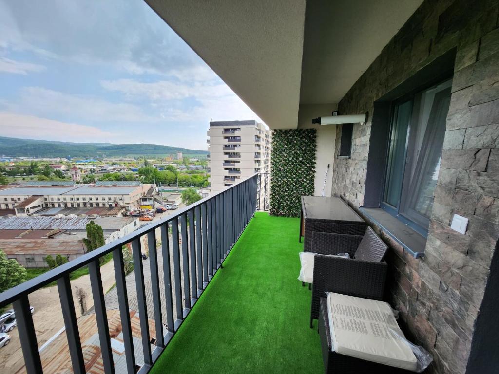 a balcony with green grass and chairs on a building at DeLux Apartments with Terassa in Towers Ever Green in Iaşi