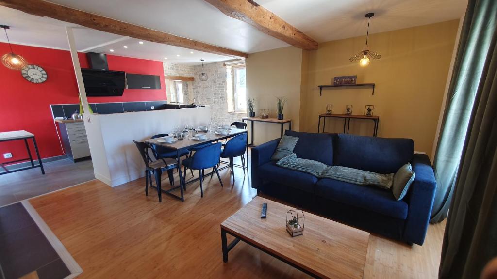 a living room with a couch and a table at appartement du croissant in Bayeux