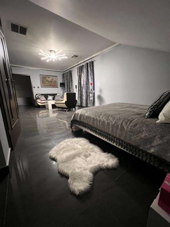 a bedroom with a bed and a white rug at Apartamenty Południe BB in Bielsko-Biała