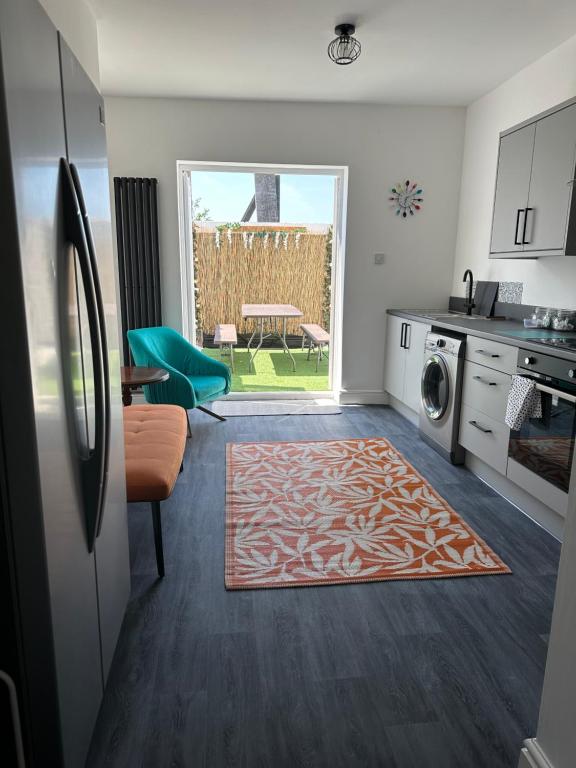 a kitchen with a living room with a rug on the floor at Quirky House Blackpool in Blackpool