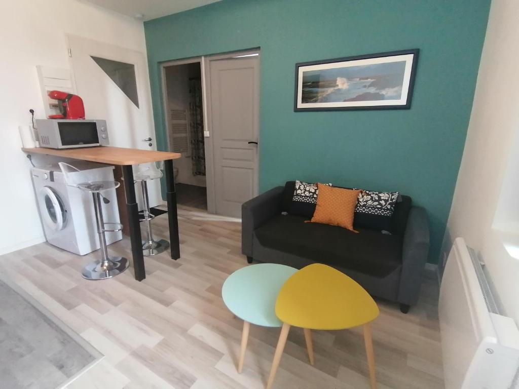 a living room with a couch and a table at La Vague Bleue, centre ville in Tonneins
