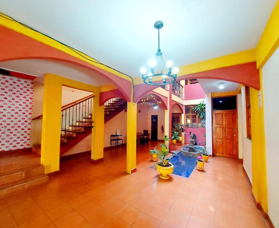 a living room with yellow and pink walls at Hostal Lolita's Boutique in Granada