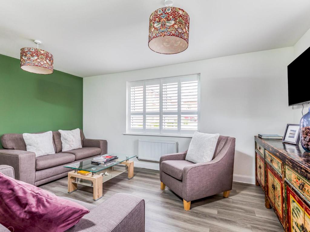 a living room with two couches and a tv at Modern Comfortable Home Pass The Keys in Chichester