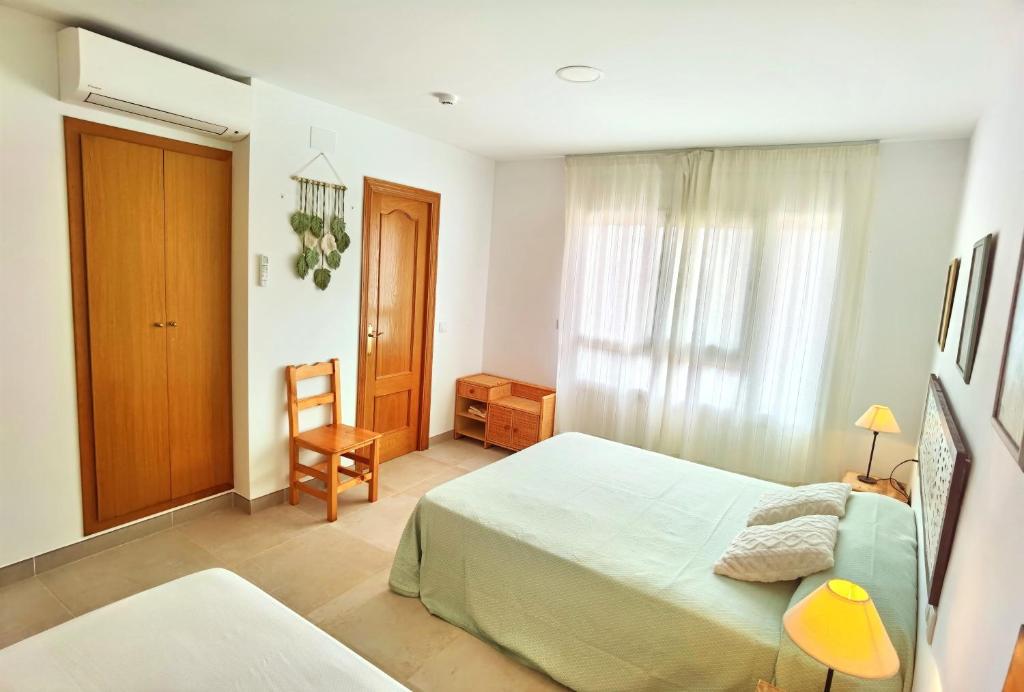 Postel nebo postele na pokoji v ubytování Hostal Noray