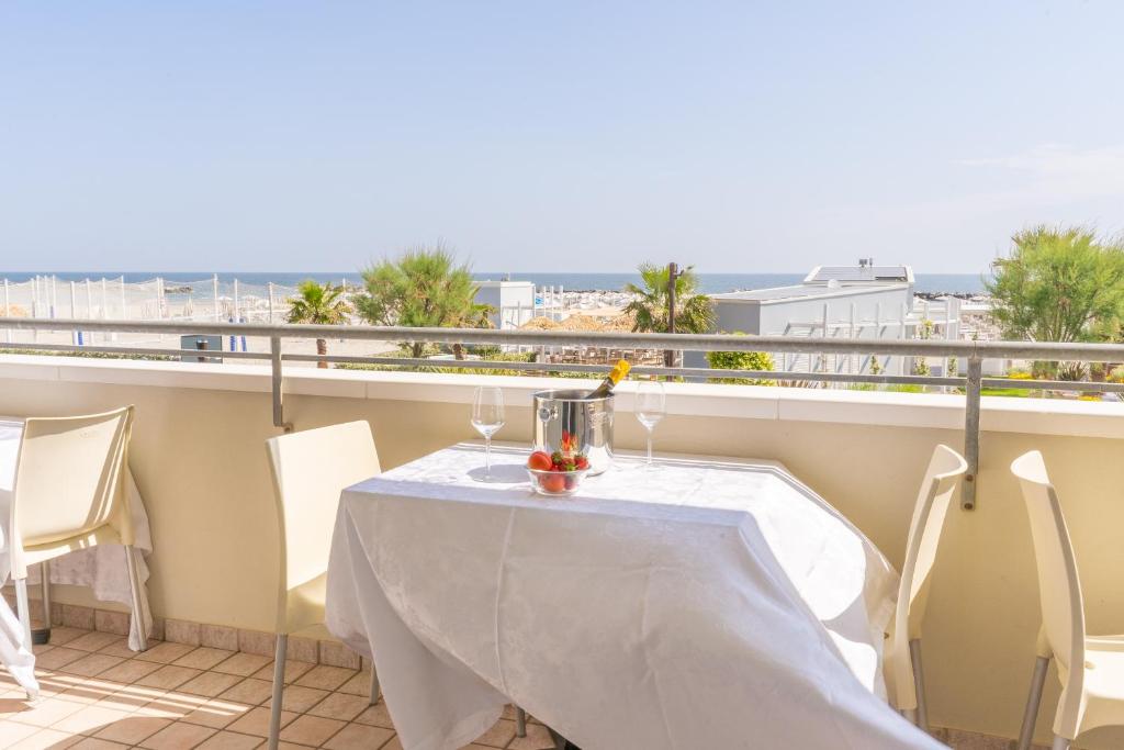a table on a balcony with a view of the ocean at Hotel Croce Del Sud in Rimini