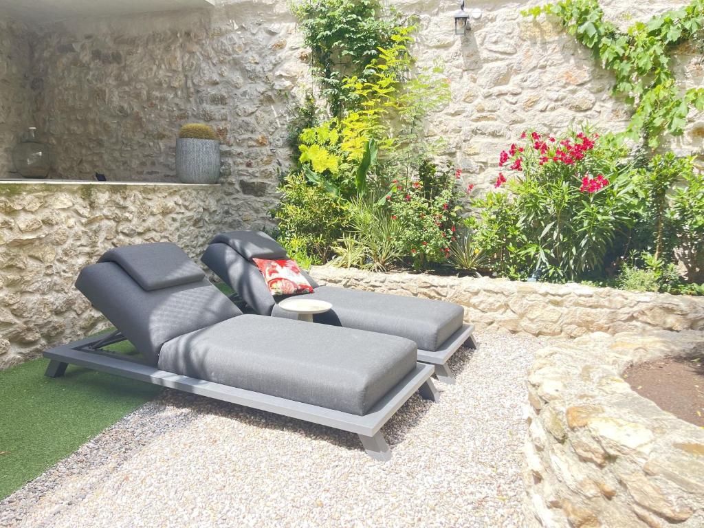 a couch sitting on the ground in a garden at L&#39;Oiseau Bleu ROLLIER in Roubia