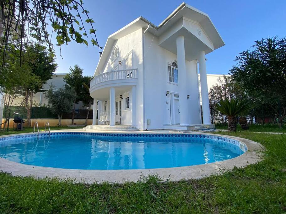 una casa blanca con una piscina frente a ella en Luxury Private Villa in the Belek Center, en Belek