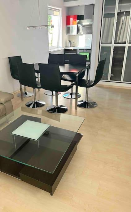 salon ze stołem i czarnymi krzesłami w obiekcie Piękny apartament blisko Malty z garazem w Poznaniu
