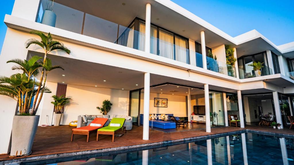 an exterior view of a house with a swimming pool at Hapier Villa in Nha Trang