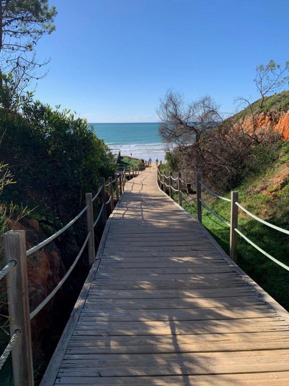 a wooden path leading down to the beach at Casa M Falésia in Albufeira