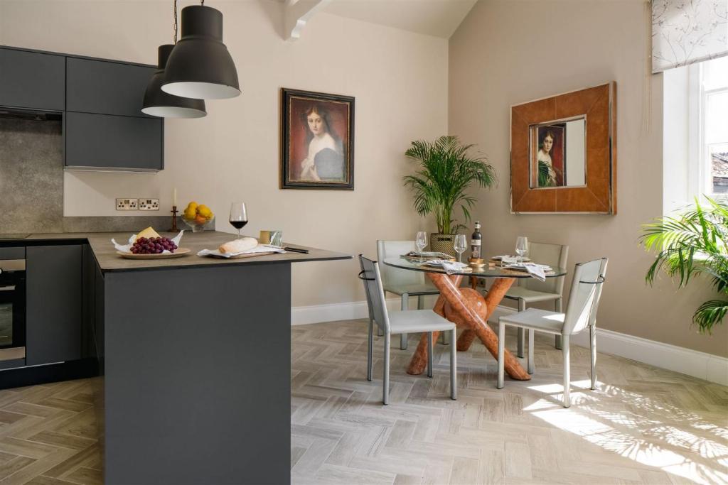 a kitchen and dining room with a table and chairs at The Upper School House in Ashburton