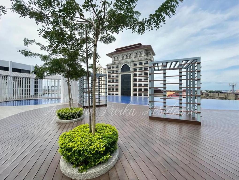 a balcony with two trees and a building at AYASOFIA TROIKA CITY VIEW ( Wifi, Netflix, 4-6 pax) in Kota Bharu