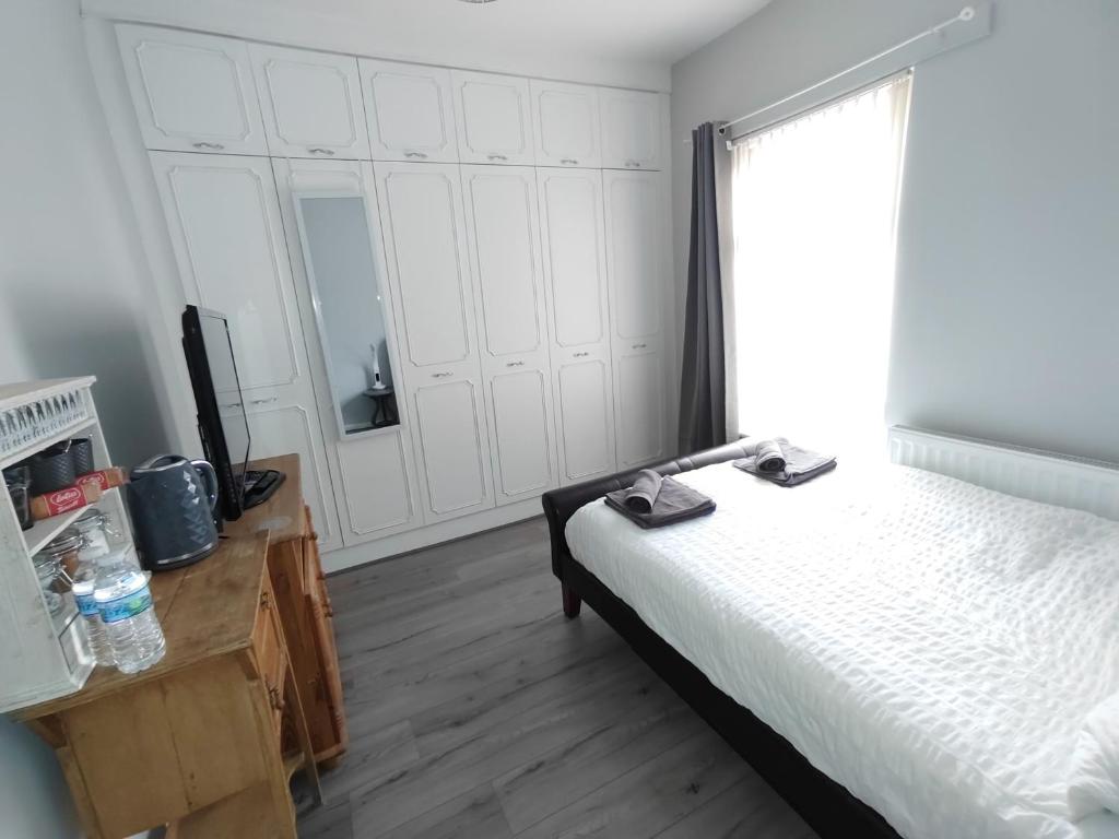 a bedroom with a bed and a large window at Double Room close to EFC LFC Liverpool City Centre in Liverpool