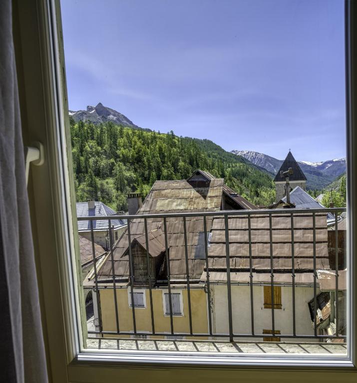 a window with a view of a building at Hotel Pascal in Allos