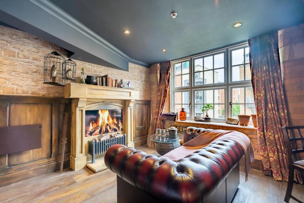 a living room with a couch and a fireplace at The Enchantment Chamber in York