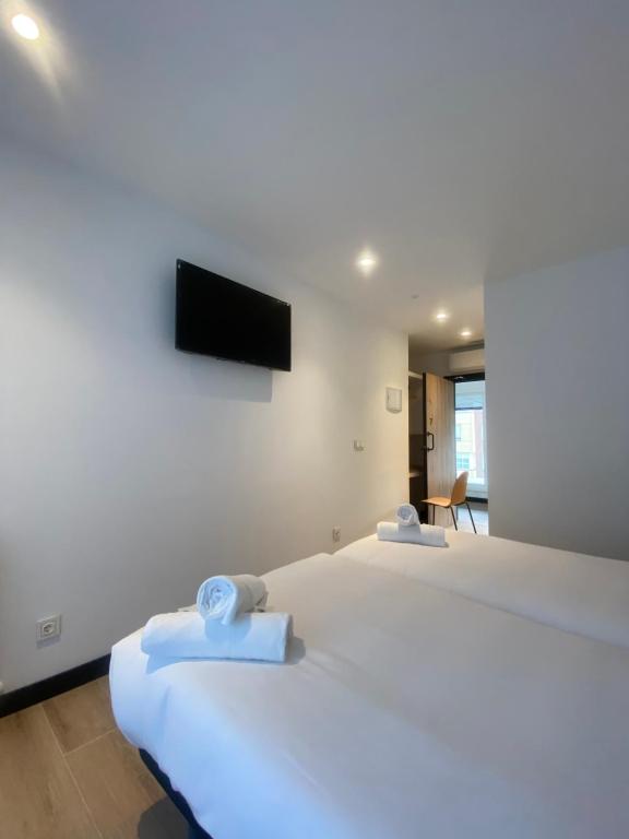 Postel nebo postele na pokoji v ubytování DONOSTIA ROOMS