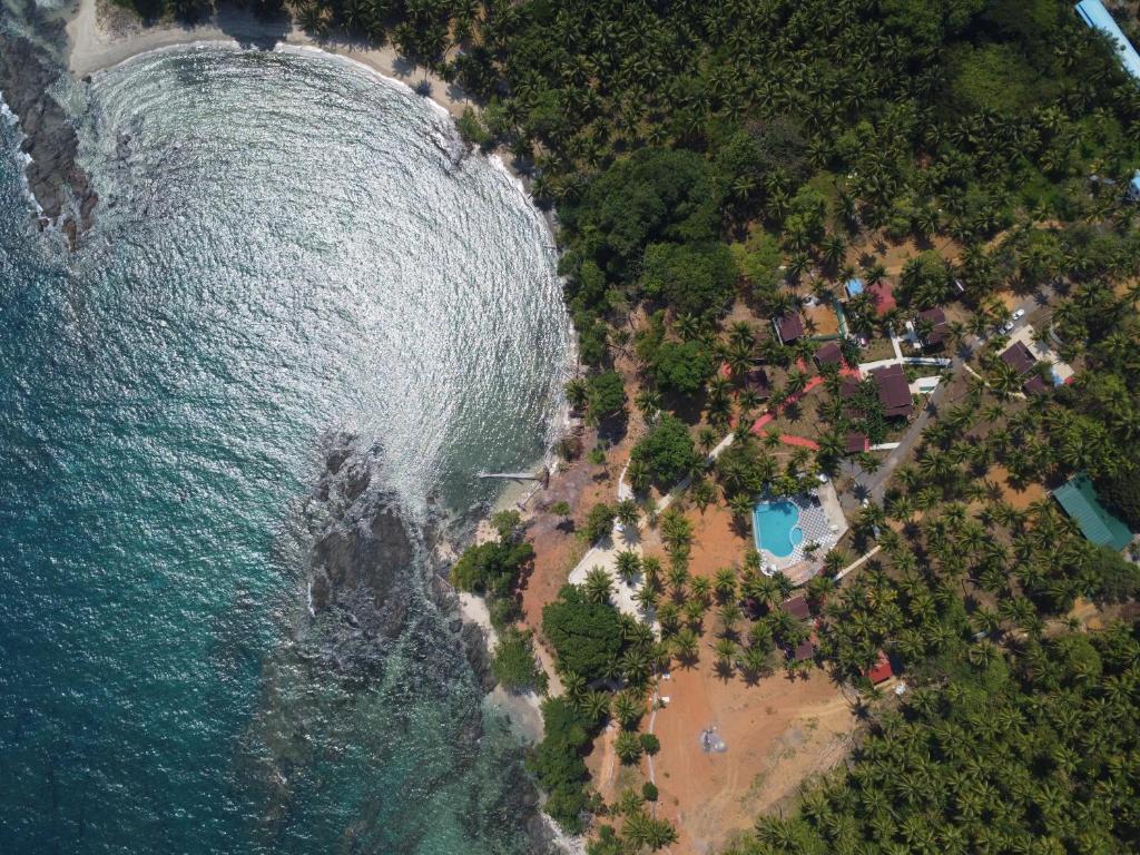 an aerial view of a beach next to the ocean at Adhvasaha Beach Spa Resort in Port Blair