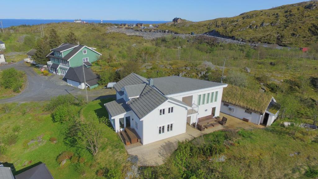 an overhead view of a large white house on a hill at Sørvågen Villa luxury home with sauna in Sørvågen