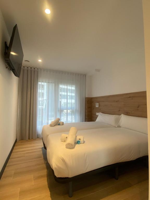 Postel nebo postele na pokoji v ubytování DONOSTIA ROOMS