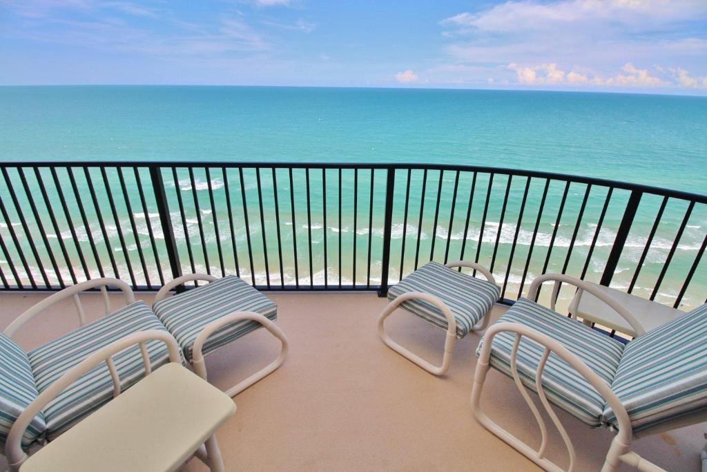 a balcony with chairs and a view of the ocean at Daytona Ashley Penthouse 4 in Daytona Beach Shores