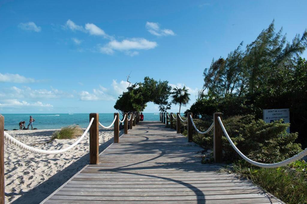 a wooden pathway to the beach with hammocks at 2 Bed 2bath Cottage Pickleball Court Pool in Providenciales