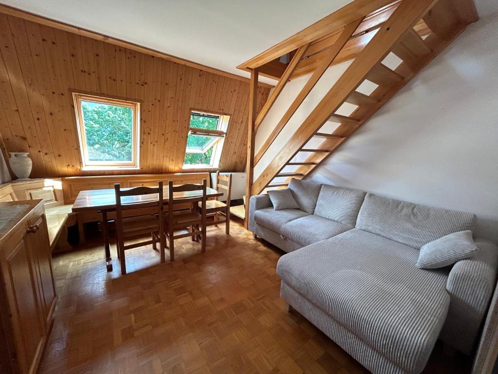 a living room with a couch and a table at BovecApartmentA in Bovec