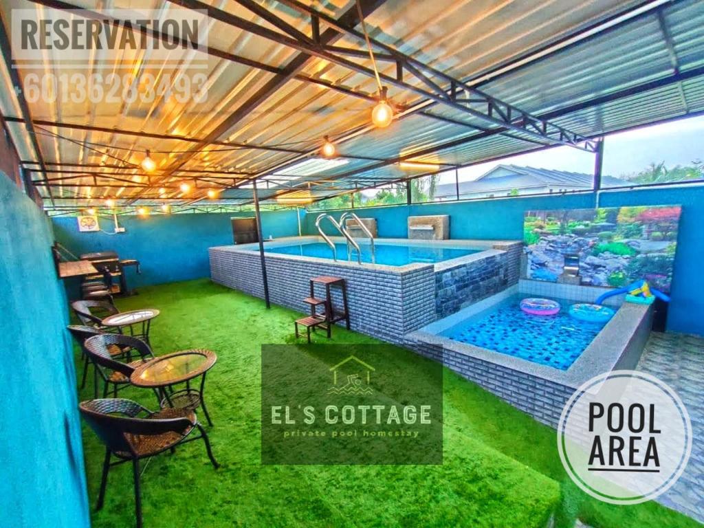 a room with a pool area with a table and chairs at El's Cottage Private Pool Homestay in Pekan