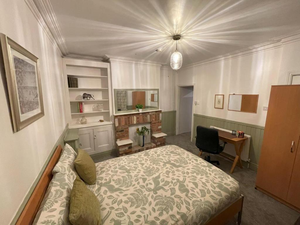 a bedroom with a bed and a desk in it at Self-Contained Ground Floor Flat in Nottingham