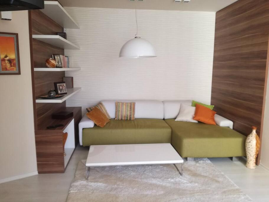 a living room with a couch and a table at Top luxury apartment, great location in Sofia