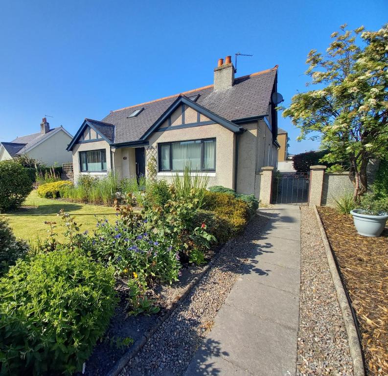 a house with a sidewalk in front of it at The Kemps Guest House in Inverness