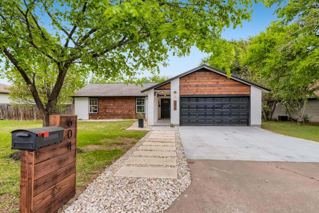 a house with a garage with a driveway at The Hiatus, Round Rock, Ideal for Family or Work in Round Rock