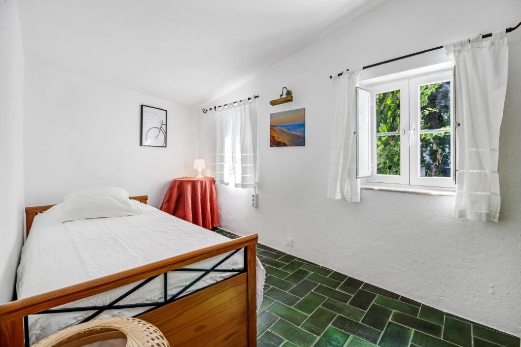 una camera da letto con un letto e una finestra di Casa do Mar - Golf Jamor a Oeiras