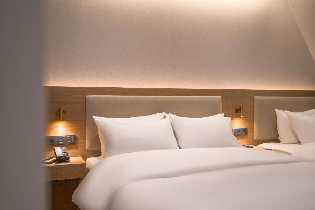 Postel nebo postele na pokoji v ubytování Comfort inn Yeouido