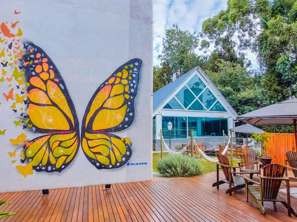 a painting of a butterfly on the side of a building at Hotel Dan Inn Campos do Jordão in Campos do Jordão