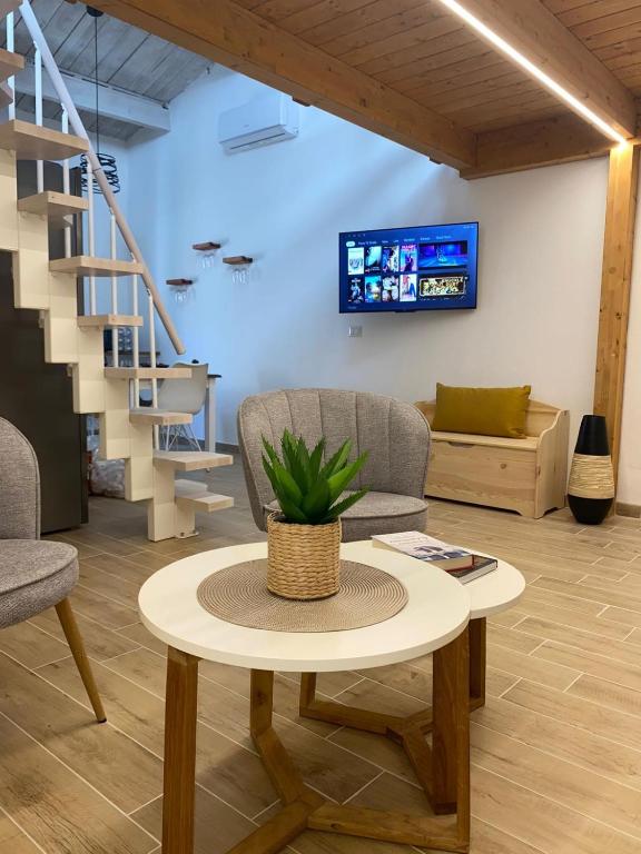 a living room with a table and a couch at Casa del Vicolo in Alghero