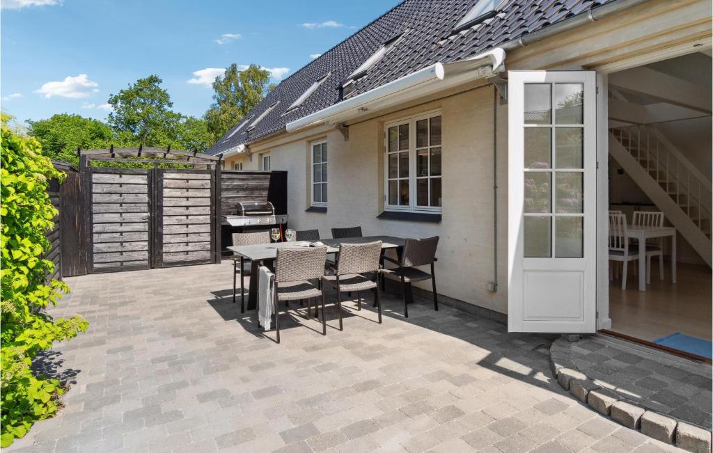 a patio with a table and chairs and a grill at 3 Bedroom Gorgeous Home In Gilleleje in Gilleleje