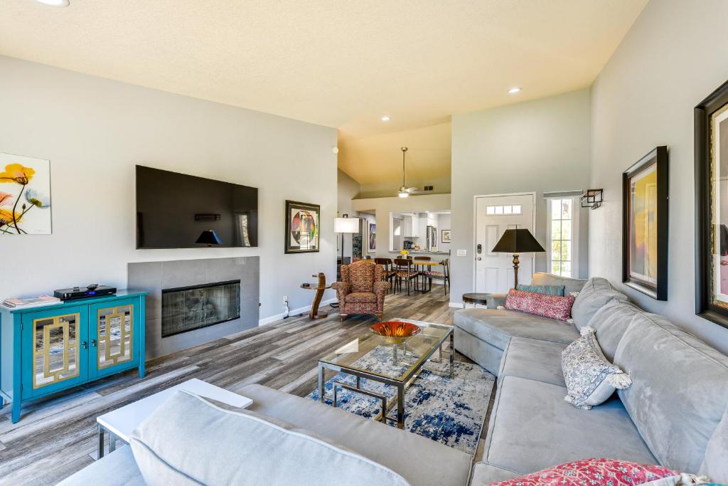 a living room with a couch and a fireplace at Newly Renovated Palm Desert Condo Community Pool! in Palm Desert