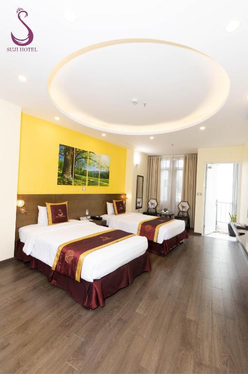 Postel nebo postele na pokoji v ubytování Suji My Dinh Hotel